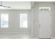 Bright living room with marble floors, white trim, and natural light from two windows at 13334 Palmera Vista Dr, Riverview, FL 33579