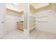 Large walk-in closet with custom shelving and built in vanity area with granite countertop at 13334 Palmera Vista Dr, Riverview, FL 33579