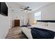 This bedroom features hardwood floors, a ceiling fan and a bath with glass shower at 1411 Gray S St, Gulfport, FL 33707
