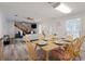 Open dining area with natural wood table, seating for six, and modern decor at 1411 Gray S St, Gulfport, FL 33707