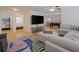 Open-concept living space with a large TV, foosball table, and a view into the bedroom at 1411 Gray S St, Gulfport, FL 33707
