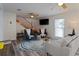 Bright living room with modern furniture, stairwell, and vinyl flooring at 1411 Gray S St, Gulfport, FL 33707
