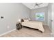Neutral bedroom featuring a ceiling fan, and light wood flooring, bathed in natural light at 1545 Illinois Rd, Clearwater, FL 33756