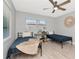Bright bedroom featuring two twin beds, ceiling fan, and light wood flooring at 1545 Illinois Rd, Clearwater, FL 33756