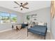 Bright bedroom featuring two twin beds, ceiling fan, and light wood flooring at 1545 Illinois Rd, Clearwater, FL 33756