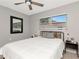 Cozy bedroom featuring a ceiling fan, wood accents and light wood flooring at 1545 Illinois Rd, Clearwater, FL 33756