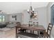 Elegant dining area featuring a wooden table, bench seating, contemporary lighting, and access to the living area at 1545 Illinois Rd, Clearwater, FL 33756