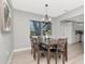 Inviting dining area featuring modern lighting, a wooden dining set, and natural light, perfect for Gathering meals at 1545 Illinois Rd, Clearwater, FL 33756