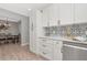Bright kitchen featuring white cabinetry, quartz countertops, and stainless steel appliances at 1545 Illinois Rd, Clearwater, FL 33756