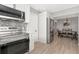 Modern kitchen with stainless steel appliances, decorative backsplash, white cabinets, and open access to the dining room at 1545 Illinois Rd, Clearwater, FL 33756