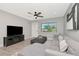 Cozy living room with a sectional sofa, large ottoman, decorative rug, and adjacent dining area at 1545 Illinois Rd, Clearwater, FL 33756
