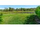 Water view from a large, grassy backyard with a black fence at 16419 Chapman Crossing Dr, Lithia, FL 33547