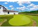 Beautiful backyard with a putting green and water view at 16419 Chapman Crossing Dr, Lithia, FL 33547