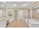 Spa-like bathroom with soaking tub, dual vanities, and a separate shower, offering a luxurious retreat at 16419 Chapman Crossing Dr, Lithia, FL 33547