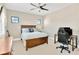 Bedroom featuring natural light, a ceiling fan, a wooden bed frame, and a desk at 16419 Chapman Crossing Dr, Lithia, FL 33547