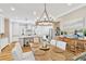 Dining area with a large table, chandelier, and views into the kitchen at 16419 Chapman Crossing Dr, Lithia, FL 33547