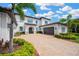 Well manicured two story home with lush landscaping and a paver driveway at 16419 Chapman Crossing Dr, Lithia, FL 33547