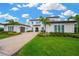 Beautiful Mediterranean-style home with lush landscaping, brick driveway, and a well-manicured lawn at 16419 Chapman Crossing Dr, Lithia, FL 33547