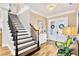 Bright foyer with hardwood floors, staircase, and decorative double doors at 16419 Chapman Crossing Dr, Lithia, FL 33547