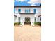 Up-close view of the front entrance with double doors and a paver driveway at 16419 Chapman Crossing Dr, Lithia, FL 33547