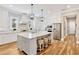 Modern kitchen featuring a large center island with seating and pendant lighting at 16419 Chapman Crossing Dr, Lithia, FL 33547