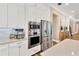 Stainless steel appliances and white cabinetry offer modern kitchen appeal at 16419 Chapman Crossing Dr, Lithia, FL 33547