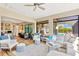 Bright living room showcasing an open floor plan, hardwood floors, and sliding glass doors leading to the pool at 16419 Chapman Crossing Dr, Lithia, FL 33547