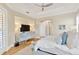 Main bedroom featuring ceiling fan, doorway, and console table with a TV at 16419 Chapman Crossing Dr, Lithia, FL 33547
