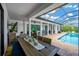 Outdoor dining area offering ample seating, overhead fans, and a view of the pool at 16419 Chapman Crossing Dr, Lithia, FL 33547