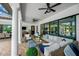 Expansive outdoor living area features comfortable seating, columns, ceiling fans, and a view of the pool at 16419 Chapman Crossing Dr, Lithia, FL 33547