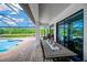 Outdoor patio with a dining table, seating, and view of the pool and backyard at 16419 Chapman Crossing Dr, Lithia, FL 33547