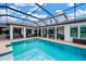 Screened pool with outdoor seating area and covered patio, perfect for entertaining at 16419 Chapman Crossing Dr, Lithia, FL 33547