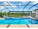 Enclosed swimming pool with a scenic view of the surrounding landscape at 16419 Chapman Crossing Dr, Lithia, FL 33547