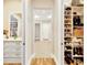 Bright walk-in closet with custom shelving and cabinets to organize shoes, purses, and clothing at 16419 Chapman Crossing Dr, Lithia, FL 33547