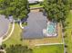 Aerial view of the home highlighting the roof, backyard pool, large lot, and the surrounding neighborhood at 1727 Woodpond Way, Lutz, FL 33559