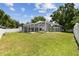 Expansive backyard featuring a screened-in patio with ample space for outdoor enjoyment and relaxation at 1727 Woodpond Way, Lutz, FL 33559