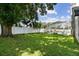 A well-maintained backyard with lush greenery and a screened-in pool area, providing a serene outdoor oasis at 1727 Woodpond Way, Lutz, FL 33559