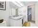 A bathroom featuring a double sink vanity with ample counter space and a well-lit mirror at 1727 Woodpond Way, Lutz, FL 33559