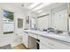 Bathroom featuring double sinks, a window offering natural light, and a clean, functional layout at 1727 Woodpond Way, Lutz, FL 33559