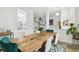 Open-concept dining area featuring a wooden table, stylish chairs, and a view into the living room at 1727 Woodpond Way, Lutz, FL 33559