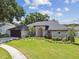 Charming single-story home with a well-manicured lawn and beautiful landscaping at 1727 Woodpond Way, Lutz, FL 33559