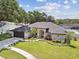 Beautiful single-story home with well-manicured landscaping, a two car garage, and inviting curb appeal at 1727 Woodpond Way, Lutz, FL 33559
