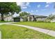 Charming single-story home with a well-manicured lawn and beautiful landscaping at 1727 Woodpond Way, Lutz, FL 33559