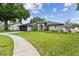 Charming single-story home with a well-manicured lawn and beautiful landscaping at 1727 Woodpond Way, Lutz, FL 33559