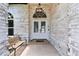 Inviting entryway with a decorative light fixture and double doors with brick entry porch at 1727 Woodpond Way, Lutz, FL 33559