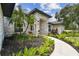 Inviting front entrance with a charming walkway and beautifully landscaped garden at 1727 Woodpond Way, Lutz, FL 33559