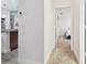 Bright hallway leading to a bedroom, showcasing modern flooring and fresh paint at 1727 Woodpond Way, Lutz, FL 33559