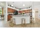Kitchen island with granite countertops, bar seating, and stainless steel faucet and open to dining area at 1727 Woodpond Way, Lutz, FL 33559