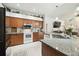 Kitchen with wood cabinets, granite countertops, and stainless steel microwave at 1727 Woodpond Way, Lutz, FL 33559
