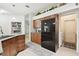 Kitchen with granite countertops, wood cabinets, and stainless steel appliances and view to laundry room at 1727 Woodpond Way, Lutz, FL 33559